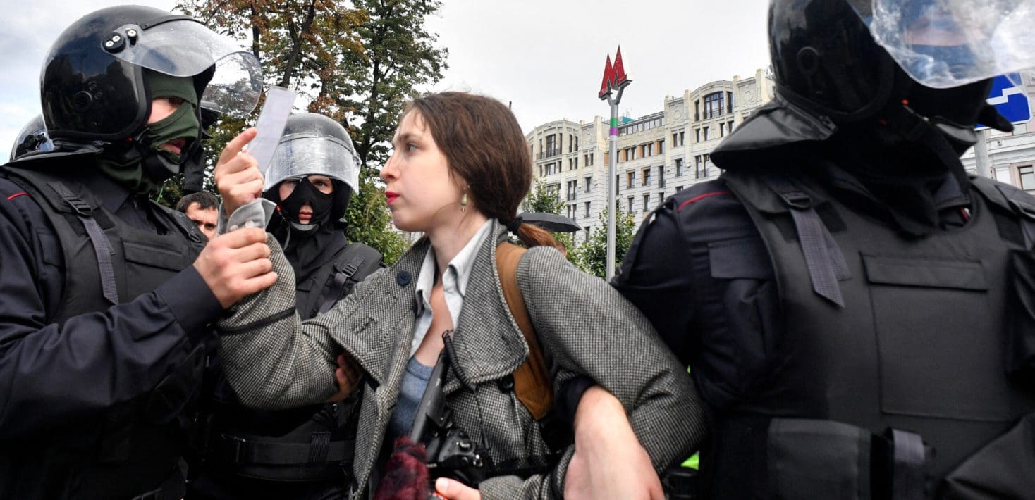 Woman being detained by police.