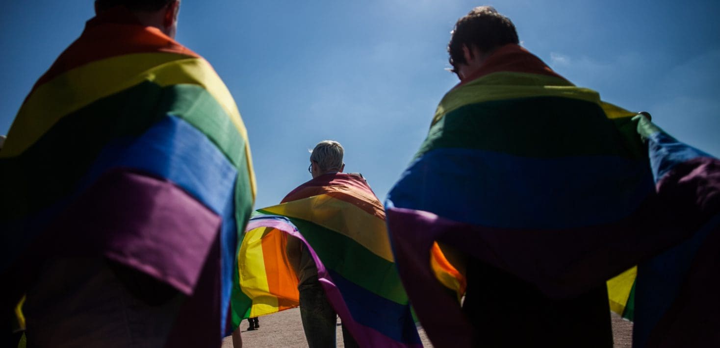 People holding Pride flags