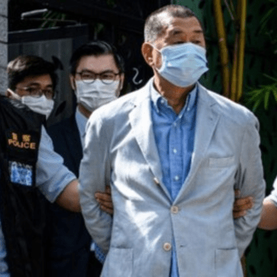 Police leading Jimmy Lai from his home after he was arrested under the National Security Law on August 10, 2020