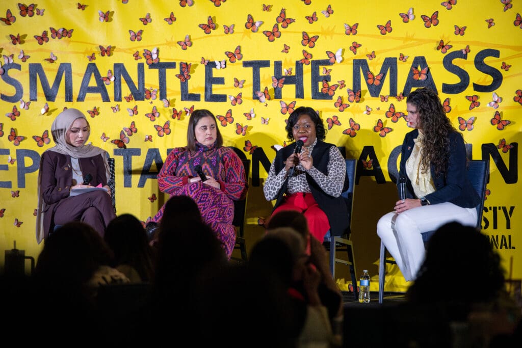 Speakers Isra Chaker, Amy Fischer, Guerline Jozef, and Jaclyn McJunkin featured on stage for presentation.