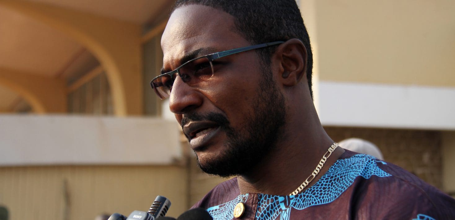 Armel Sayo speaking with a microphone
