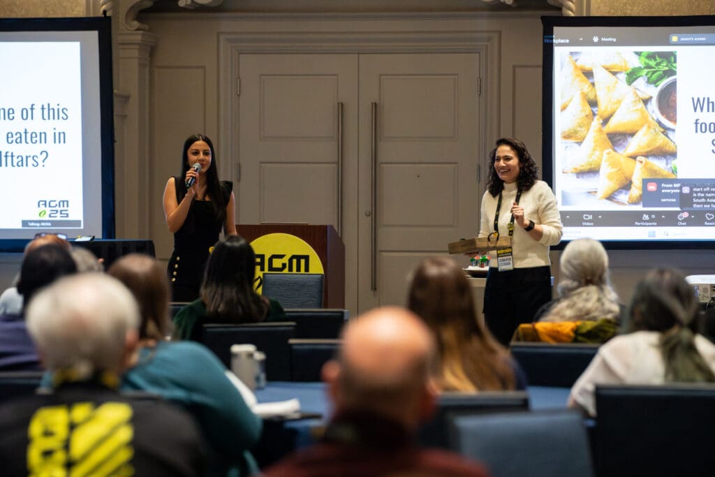 Shaheera Abbasi, AIUSA Outreach Coordinator (pictured on the left) and Jennifer Estrada, AIUSA Community Program Manager for Grassroots Leadership & Engagement (pictured on the right) present in front of audience.