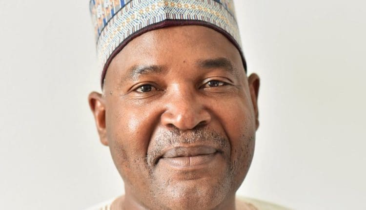Moussa Tchangari poses for a portrait, with a slight smile on his face and a traditional Muslim cap on his head.