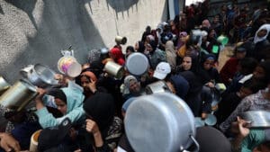 Palestinian women gather at a hot meal distribution point in Nuseirat in the central Gaza Strip, June 4, 2025.