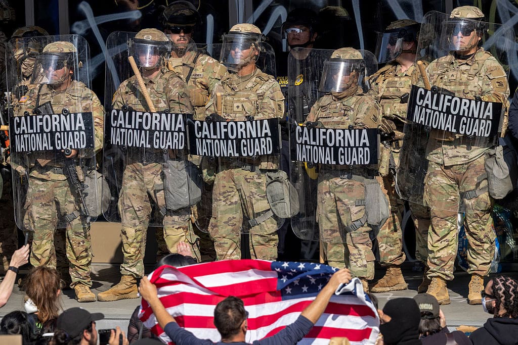 Protesters confront California National Guard soldiers and police outside of a federal building as protests continue in Los Angeles following three days of clashes with police after a series of immigration raids on June 09, 2025 in Los Angeles, California.
