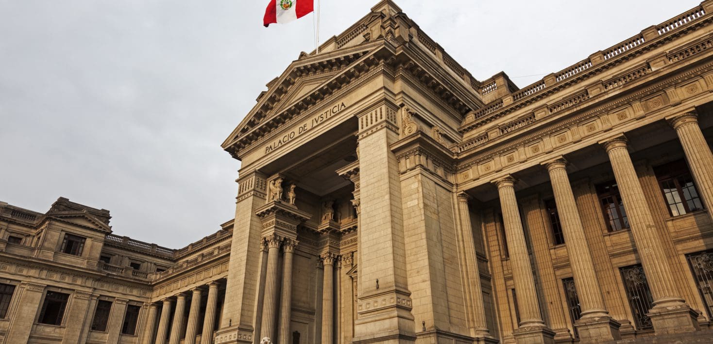 A tall, imposing monumental sandstone building with columns, reading