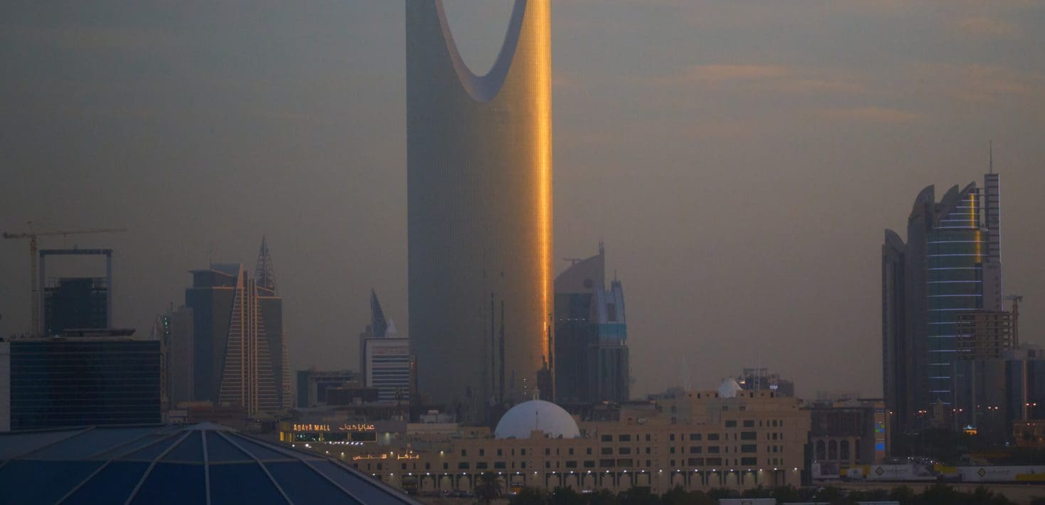 Tall buildings and domes mark the skyline at dusk.