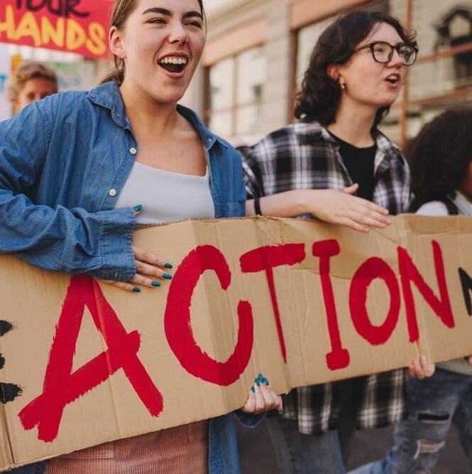 Global,Climate,Strike.,Vibrant,Young,People,Holding,A,Banner,While