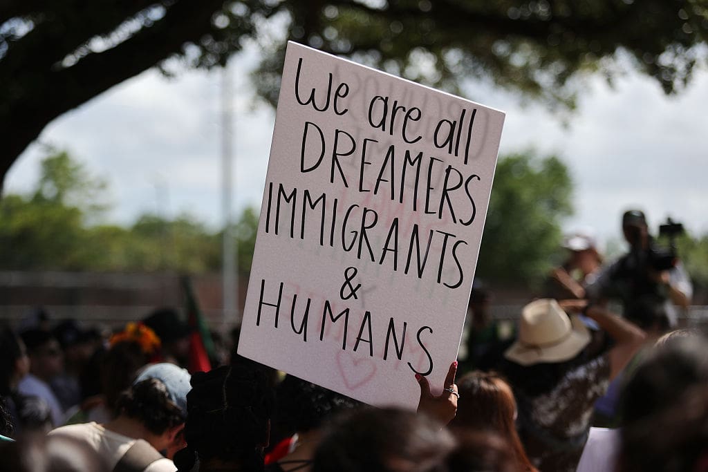 Protesters gather at Ervan Chew Park in Houston, Texas, on June 8, 2025, for a demonstration against Trump immigration policies and mass deportations.