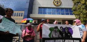 people protesting outside a government building in El Salvador