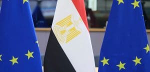 An Egyptian flag stands in the middle of two EU flags
