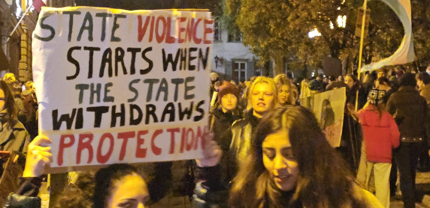 Protesters in Riga holding signs against state withdrawal of protections for women