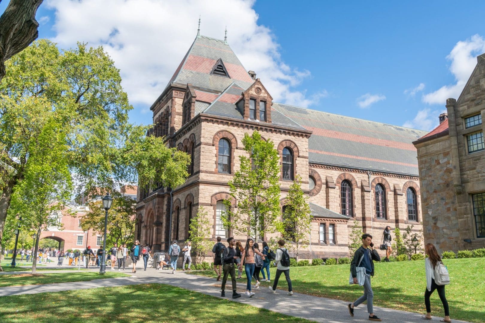 A brown college building at Brown University, with students walking by.