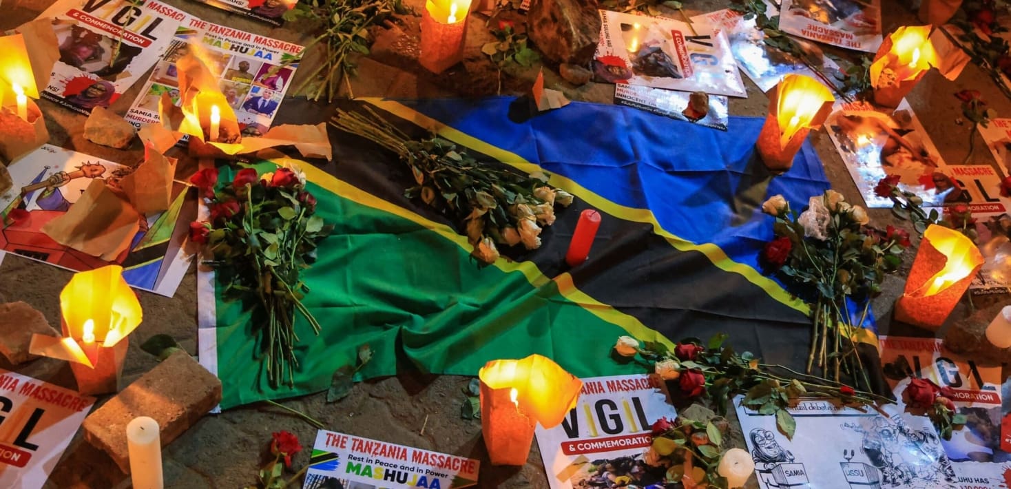 Flowers, candles and fliers reading 