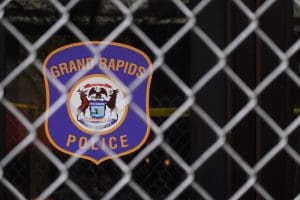 Grad Rapids Police sign behind a fence