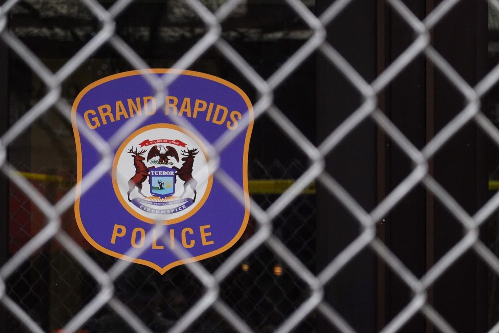 Grad Rapids Police sign behind a fence