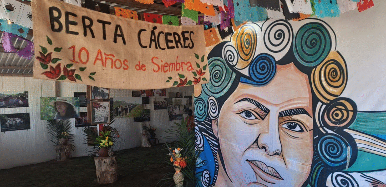 banner and painting face of Berta Caceres