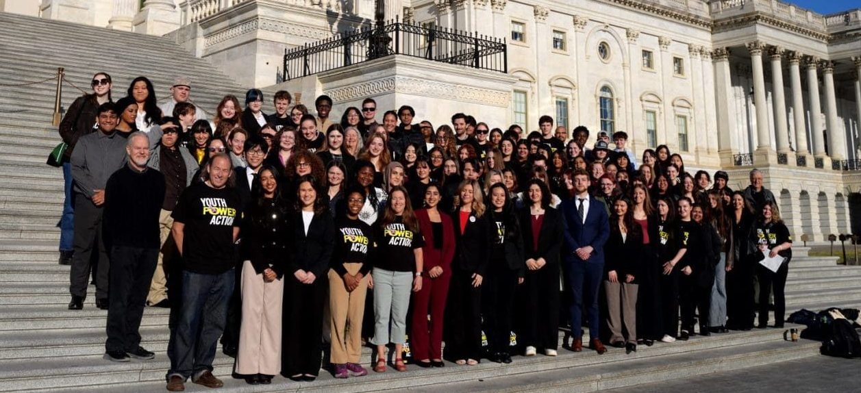 A group of students standing on steps in front of Capitol Hill.