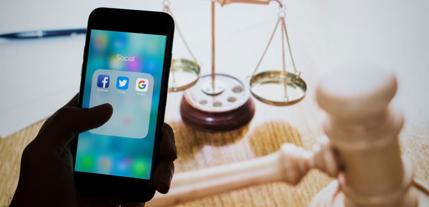 iphone placed in front of scales of justice