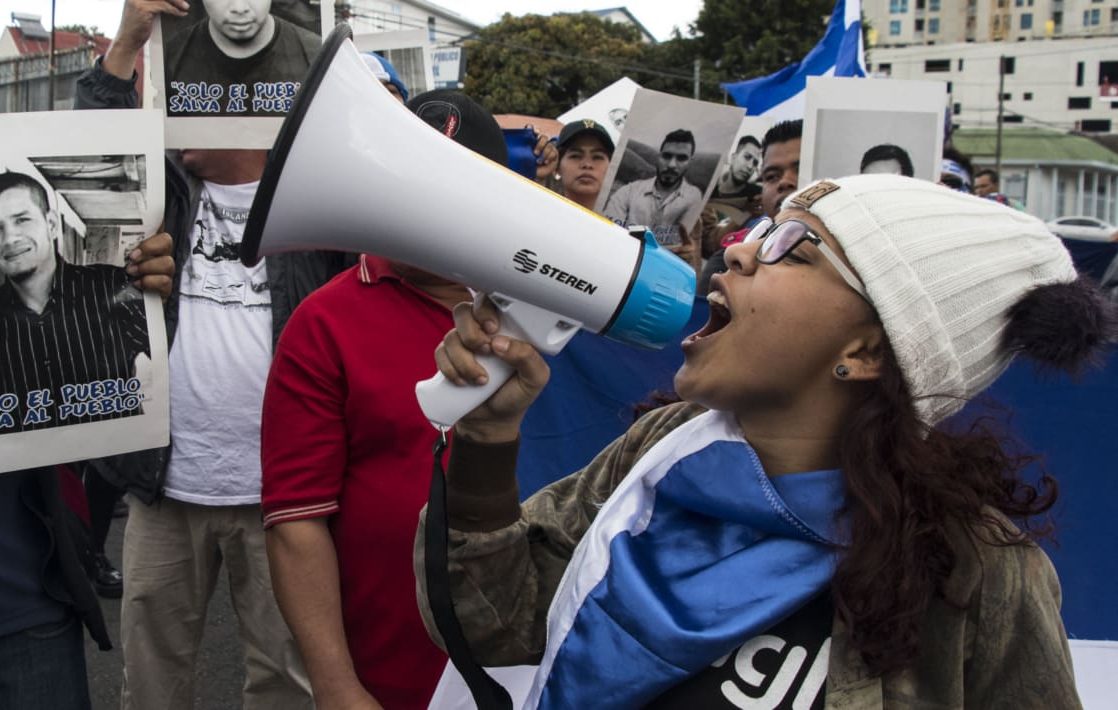 woman speaking into bull horn