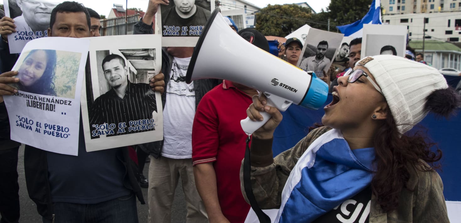 woman speaking into bull horn