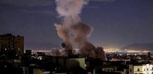 city at night with smoke from a bomb