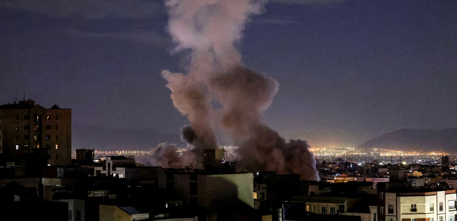 city at night with smoke from a bomb