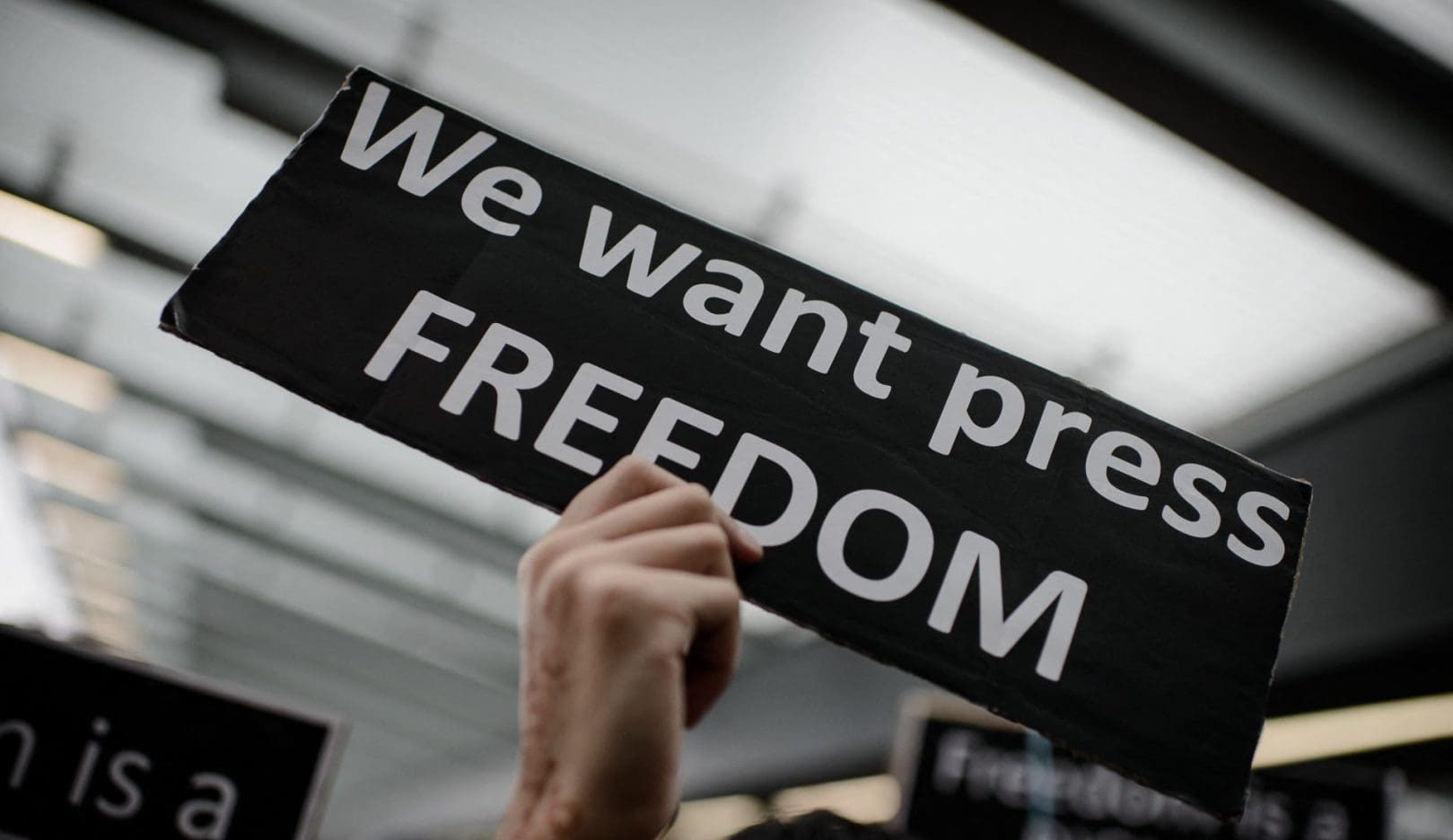 A protester displays a placard during a rally to support press freedom in Hong Kong