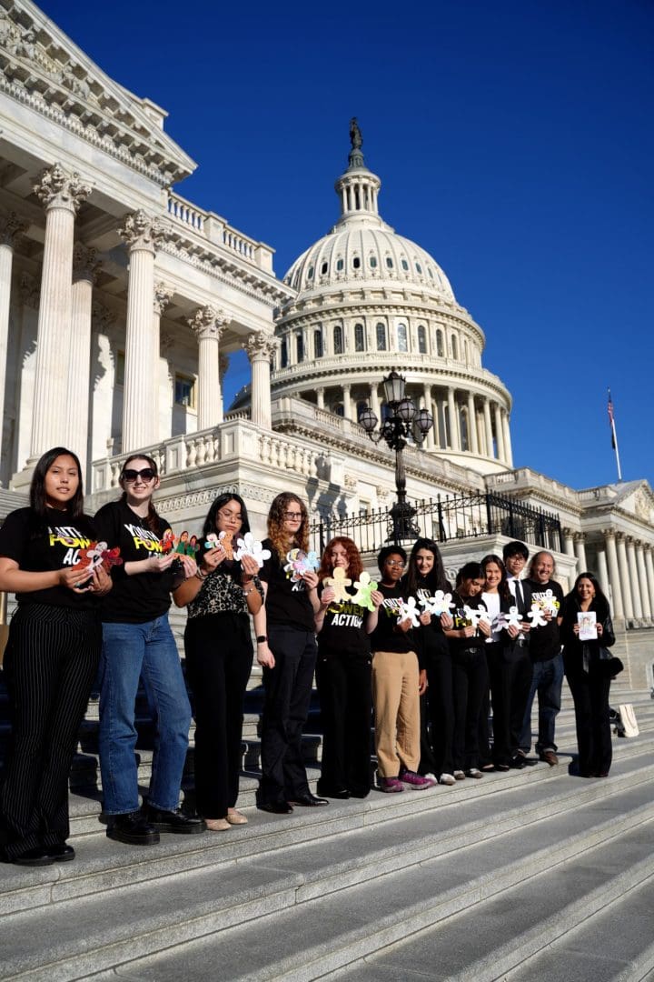 AIUSA youth hold paper dolls for the Paper Dolls to Free Families national campaign.