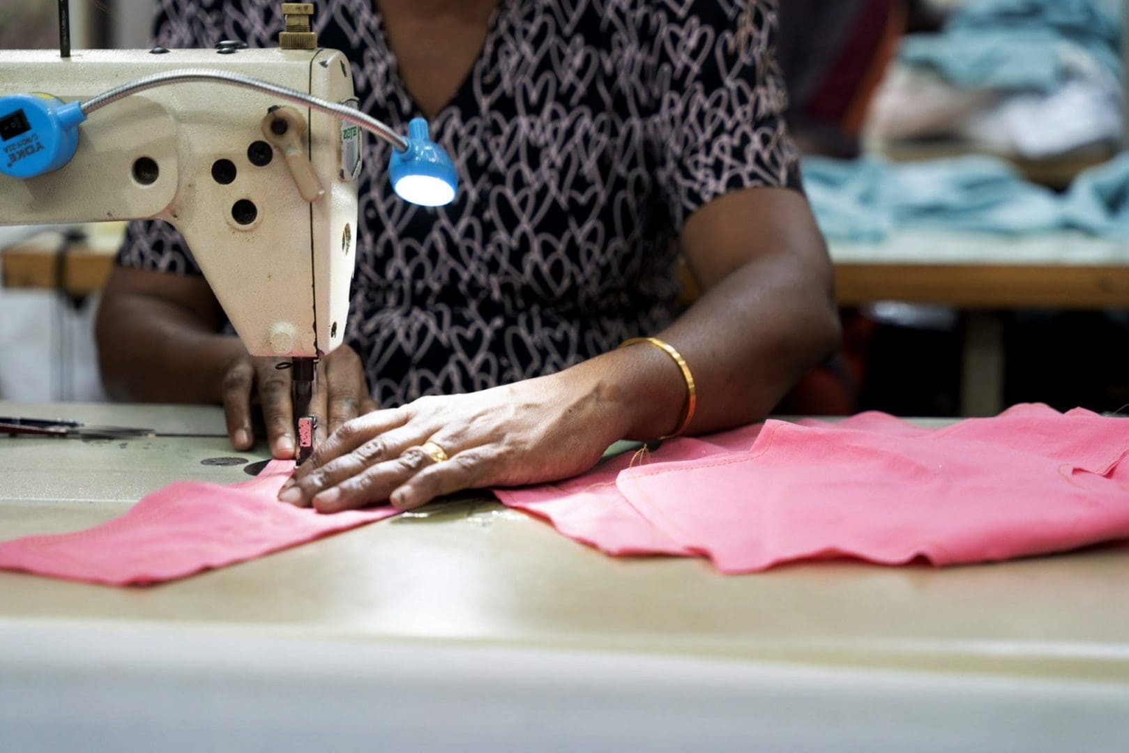 A garment worker sewing clothing.
