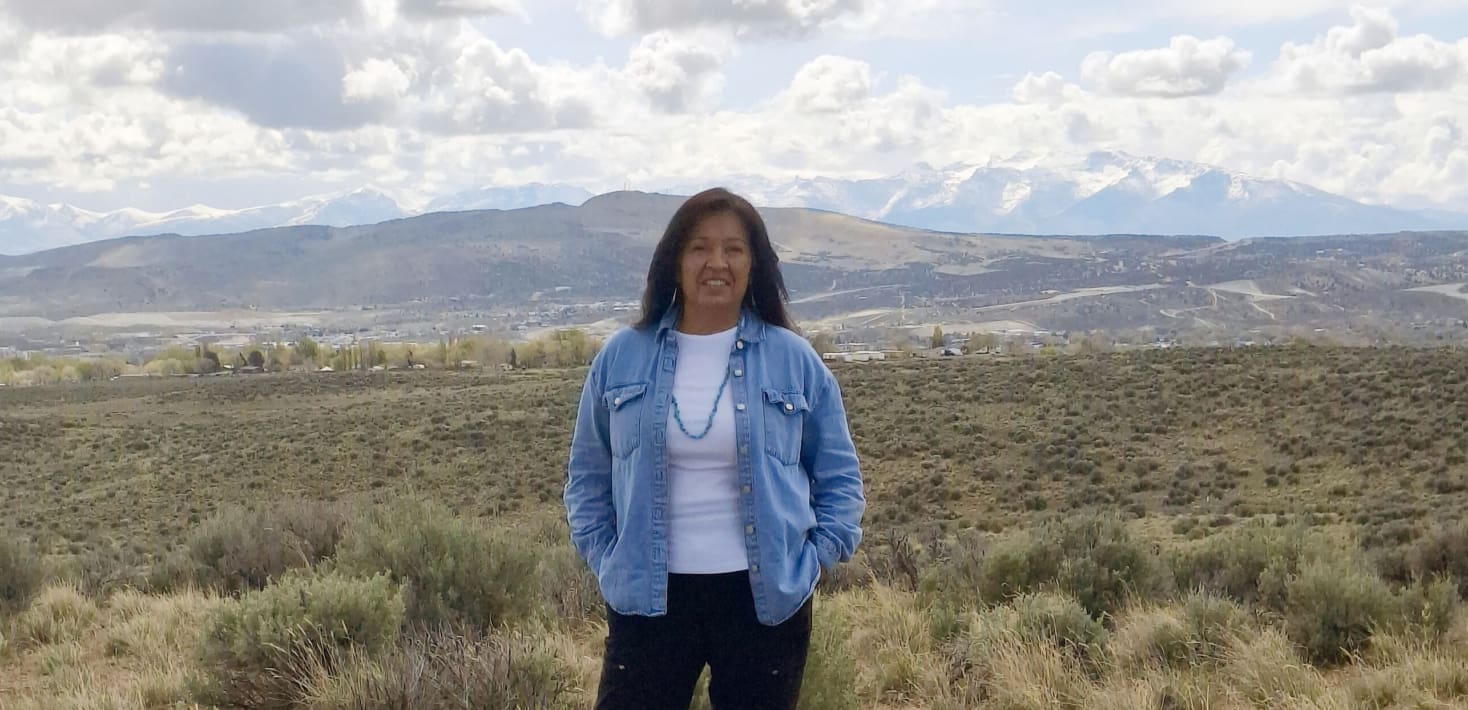 Fermina Stevens standing on their land.