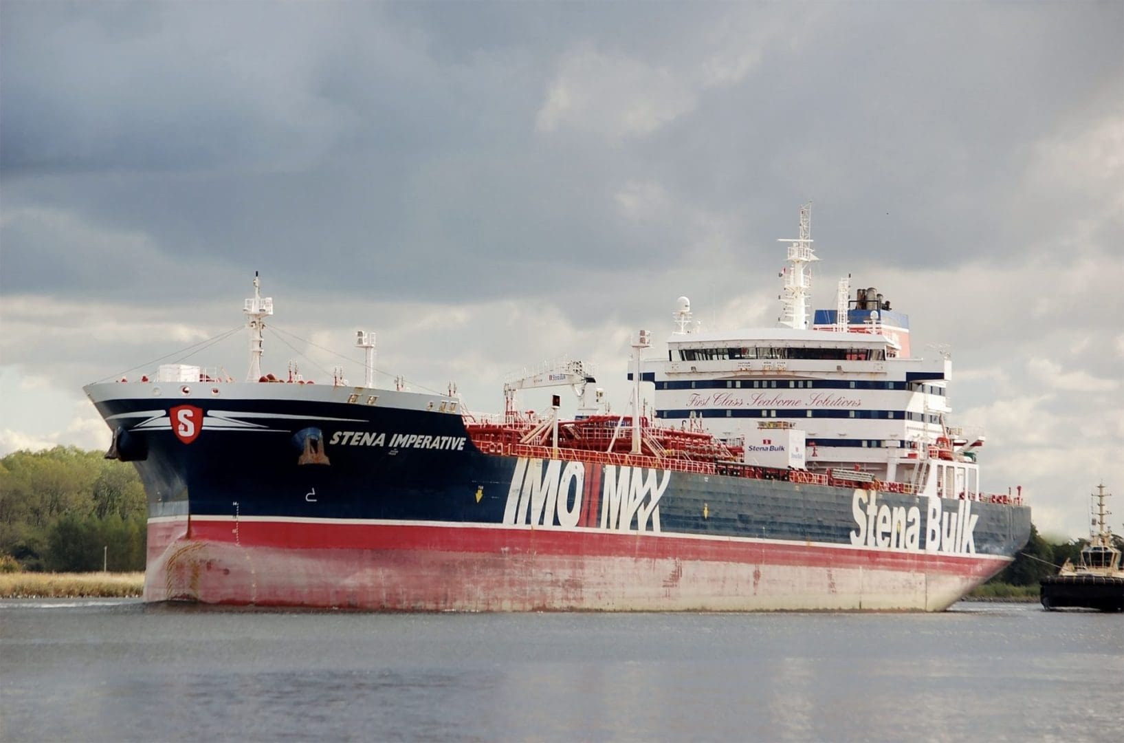 A large black and white tanker ship sits in a harbor, the side reads STENA IMPERATIVE, IMO MAX, and STENA BULK.