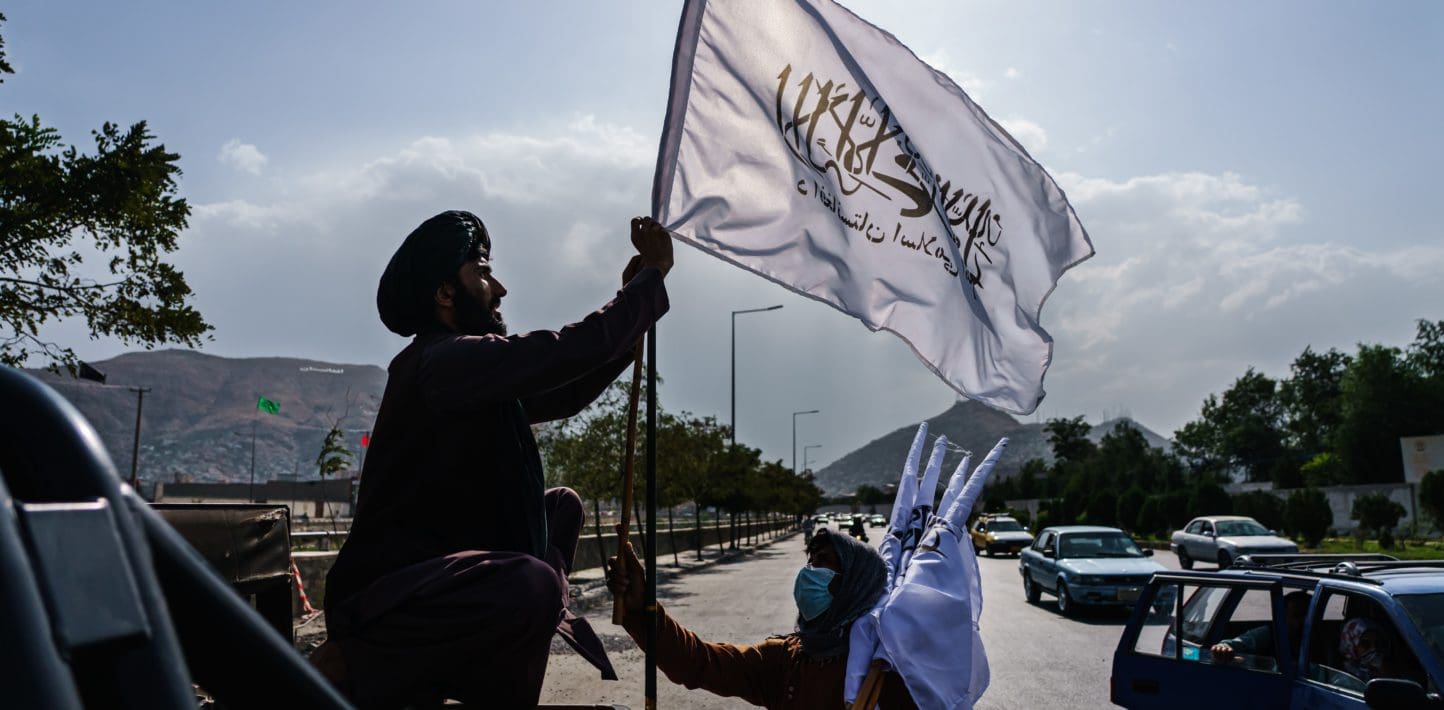 A man waving a white flag in the air.