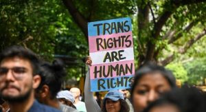 A woman holding up a poster at a protest that reads 