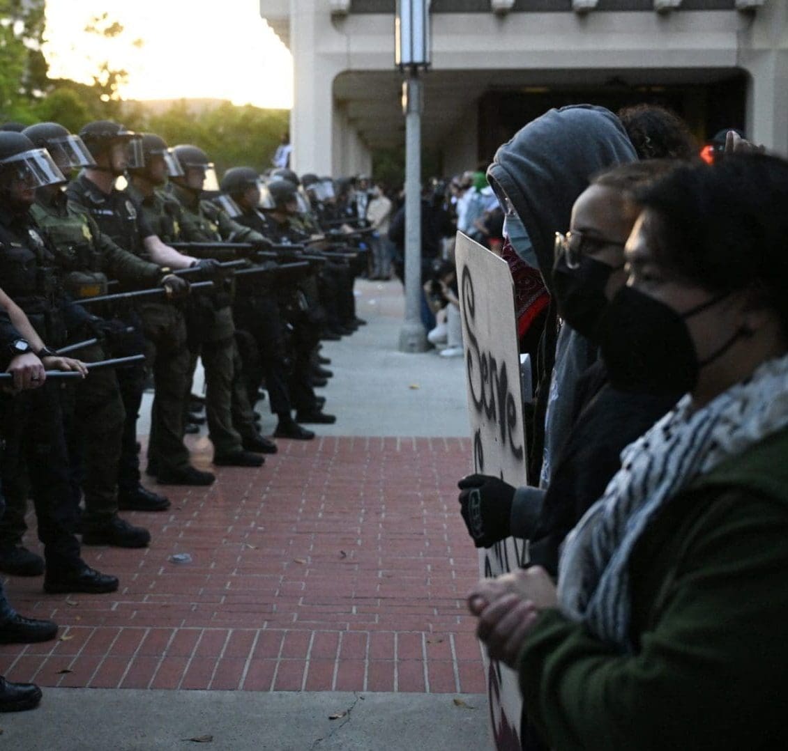 Police officers and pro-Palestinian demonstrators face off after students occupied the Physical Sciences Lecture Hall at the University of California, Irvine, in Irvine, California on May 15, 2025.