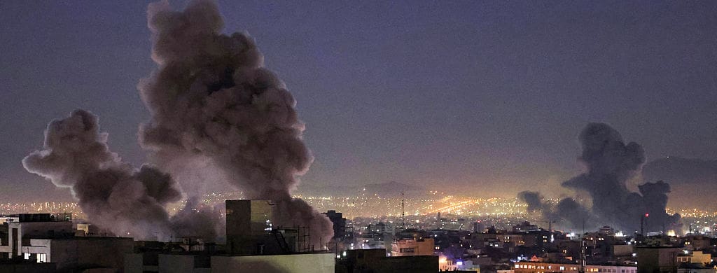 city with smoke from bombing