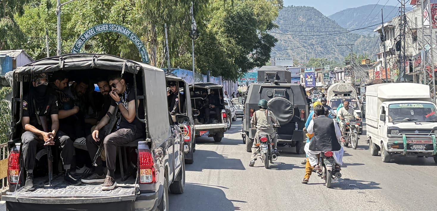 Cars, trucks, and motorbikes in traffic in Pakistan.