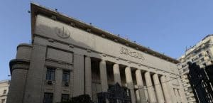 A large imposing court building with tall columns half in shadow.