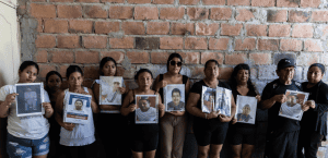 People in Ecuador holding photos of people that have dissappeared