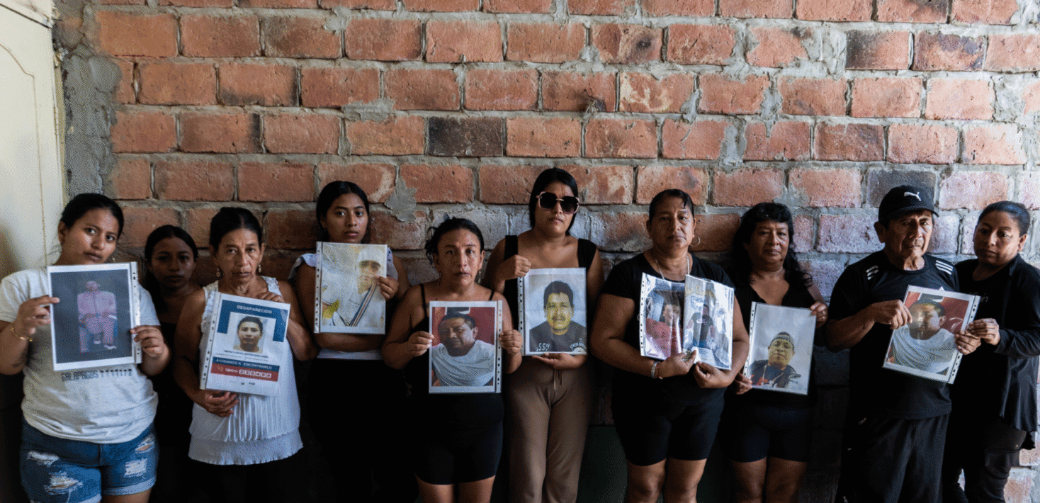 People in Ecuador holding photos of people that have dissappeared