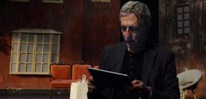 A man looking at an iPad.