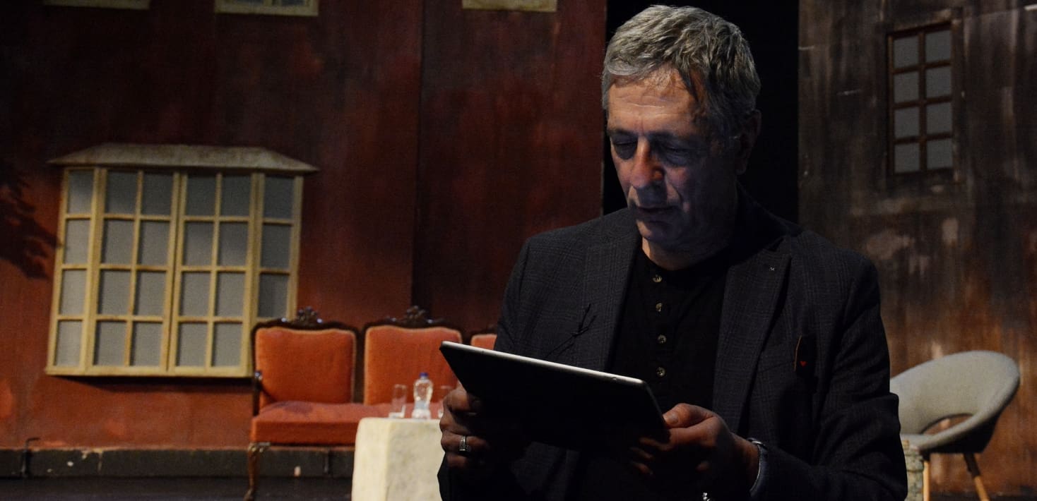A man looking at an iPad.