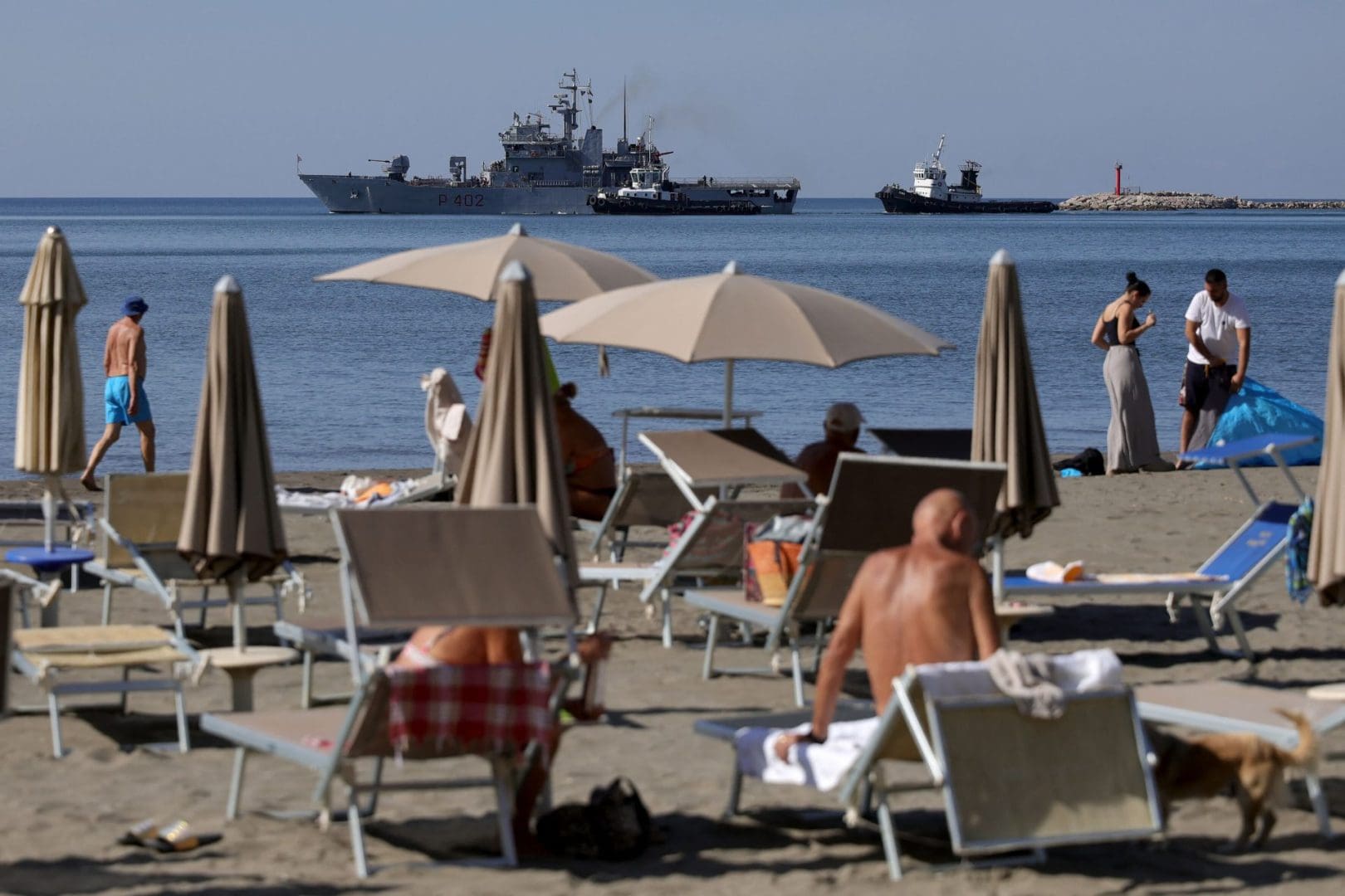 A navy boat leaves the Shengjin port in Albania after bringing migrants intercepted in Italian waters to a centre in the northern port of Shengjin for registration and health checks