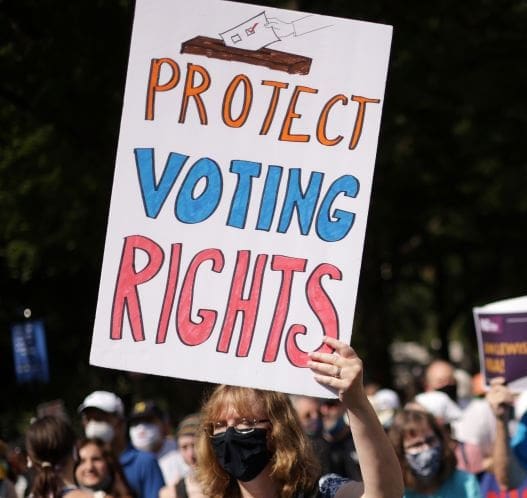 WASHINGTON, DC - AUGUST 28: Activists participate in a March On For Voting Rights August 28, 2021 in Washington, DC. Voting rights activists gathered in Washington to mark the 58th anniversary of the 1963 March On Washington, where Dr. Martin Luther King delivered his “I Have a Dream” speech, and urged the Senate to pass voting rights legislations.