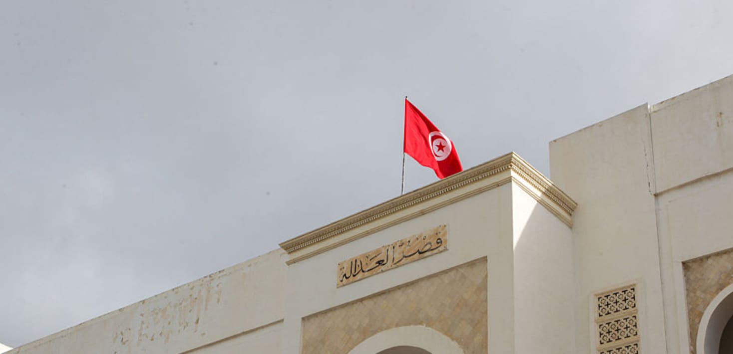 The Tunisian flag atop an official looking building.