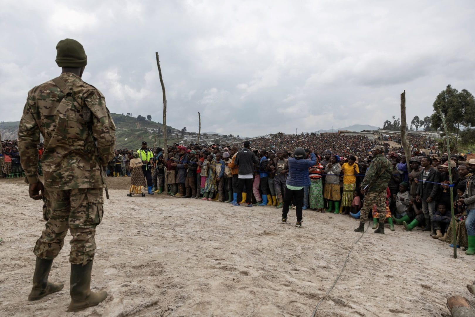 Miners gather during a M23 movement rally at the mine in Rubay on March 5, 2025.