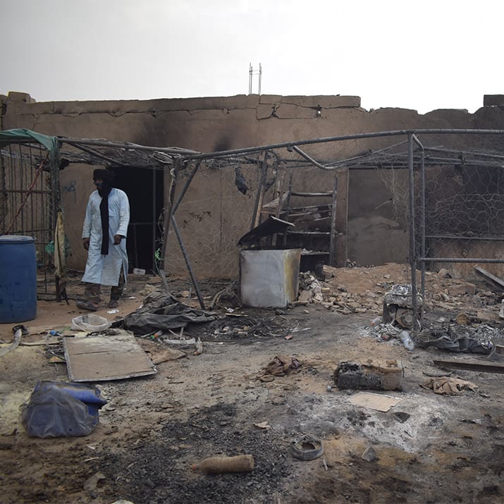 A man walks past a structure damaged in a drone attack allegedly carried out by the Malian army near the Algerian border in Talhandak on 8 July 2026.