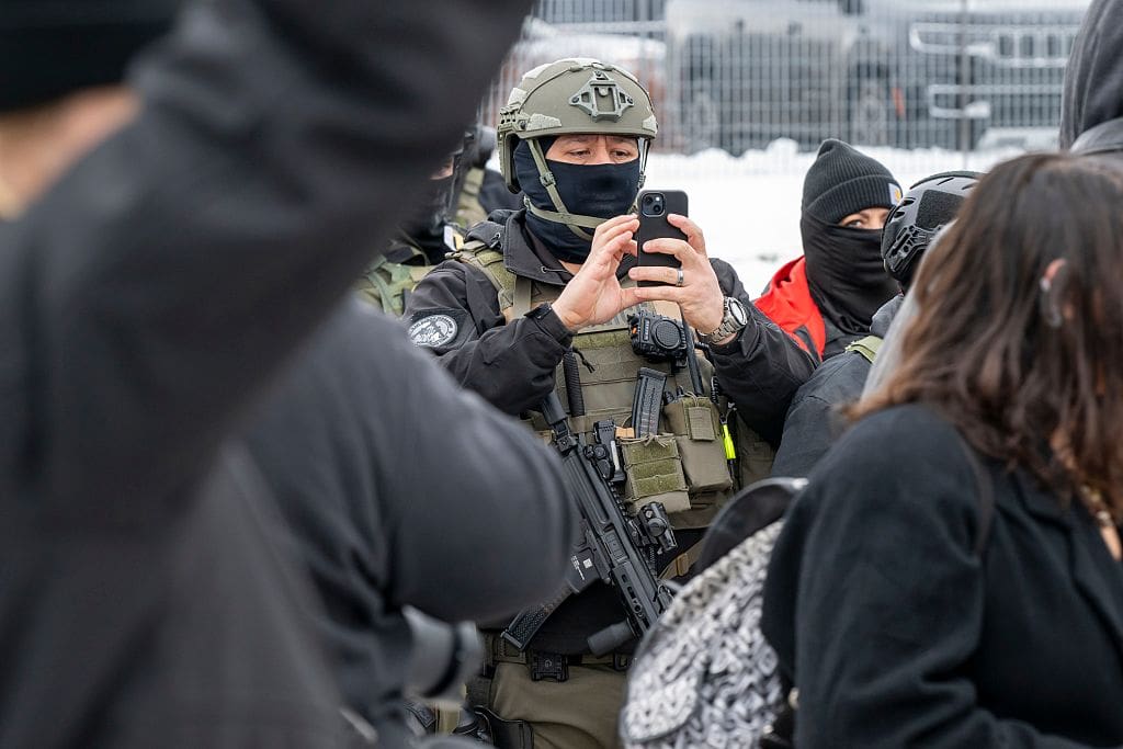Police agent taking video of the protesters on his phone at protest at the Whipple Federal building in response to the shooting of a woman by an Immigration and Customs Enforcement officer in Minneapolis, Minnesota, January 8, 2026,