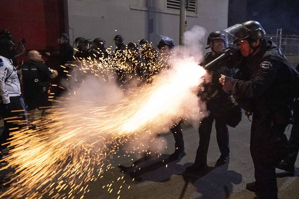 Los Angeles Police Department (LAPD) officers aim and fire less-lethal launchers (40mm foam batons) at demonstrators during a dispersal operation in downtown Los Angeles, California, United States on January 30, 2026.