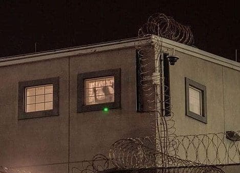 A detainee stands against a window inside the federal immigration center at Delaney Hall, where ICE is housing detained immigrants on May 27, 2026 in Newark, New Jersey.